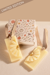 Two scented wax tablet with floral designs on a beige surface, featuring a box.